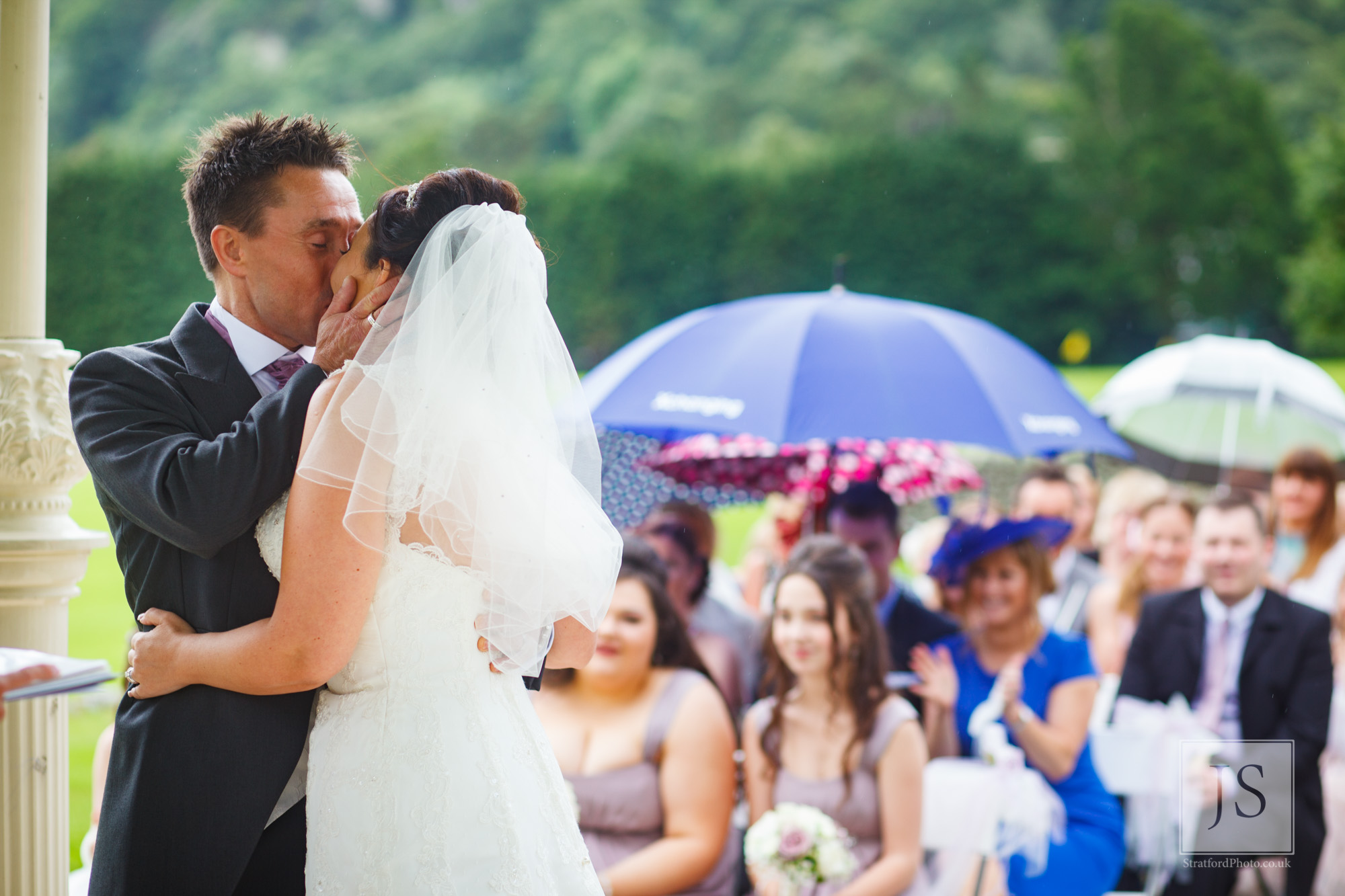 A groom kisses his bride at the altar.jpg