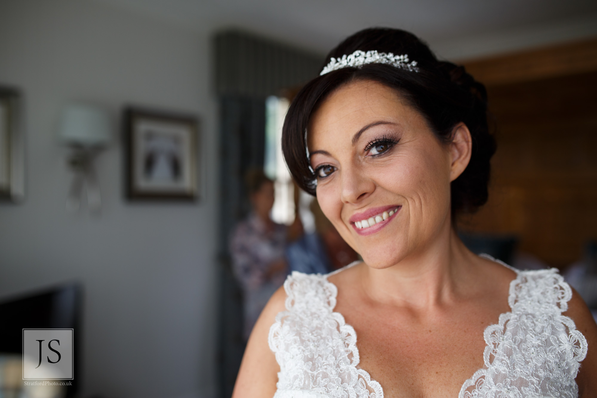 A radiant bride smiles on her wedding morning.jpg