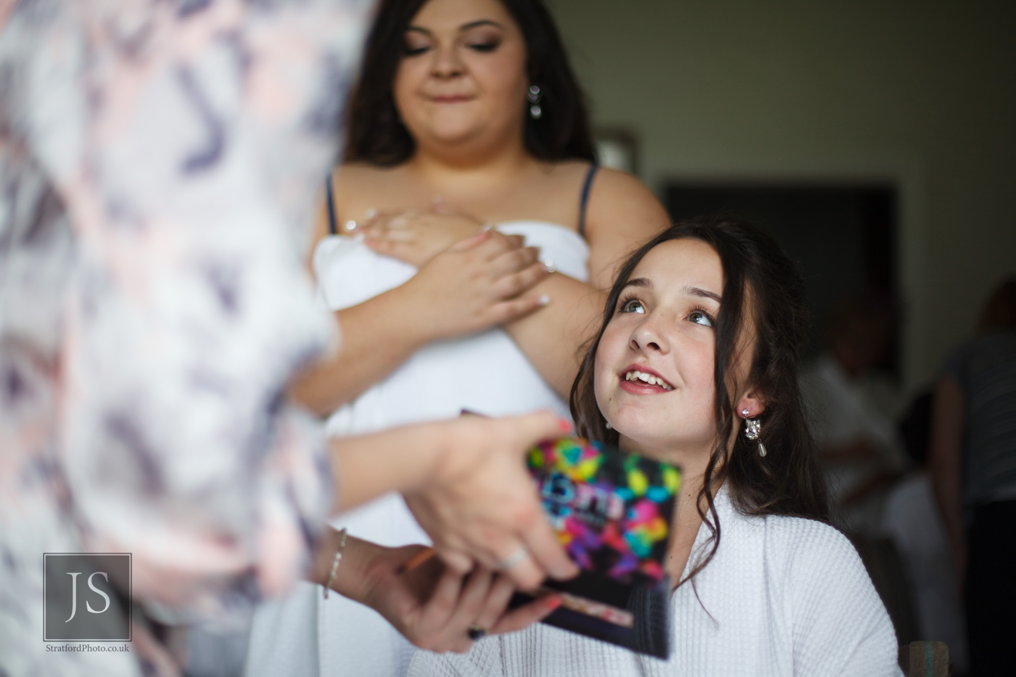 A young bridesmaid adires her makeup.jpg
