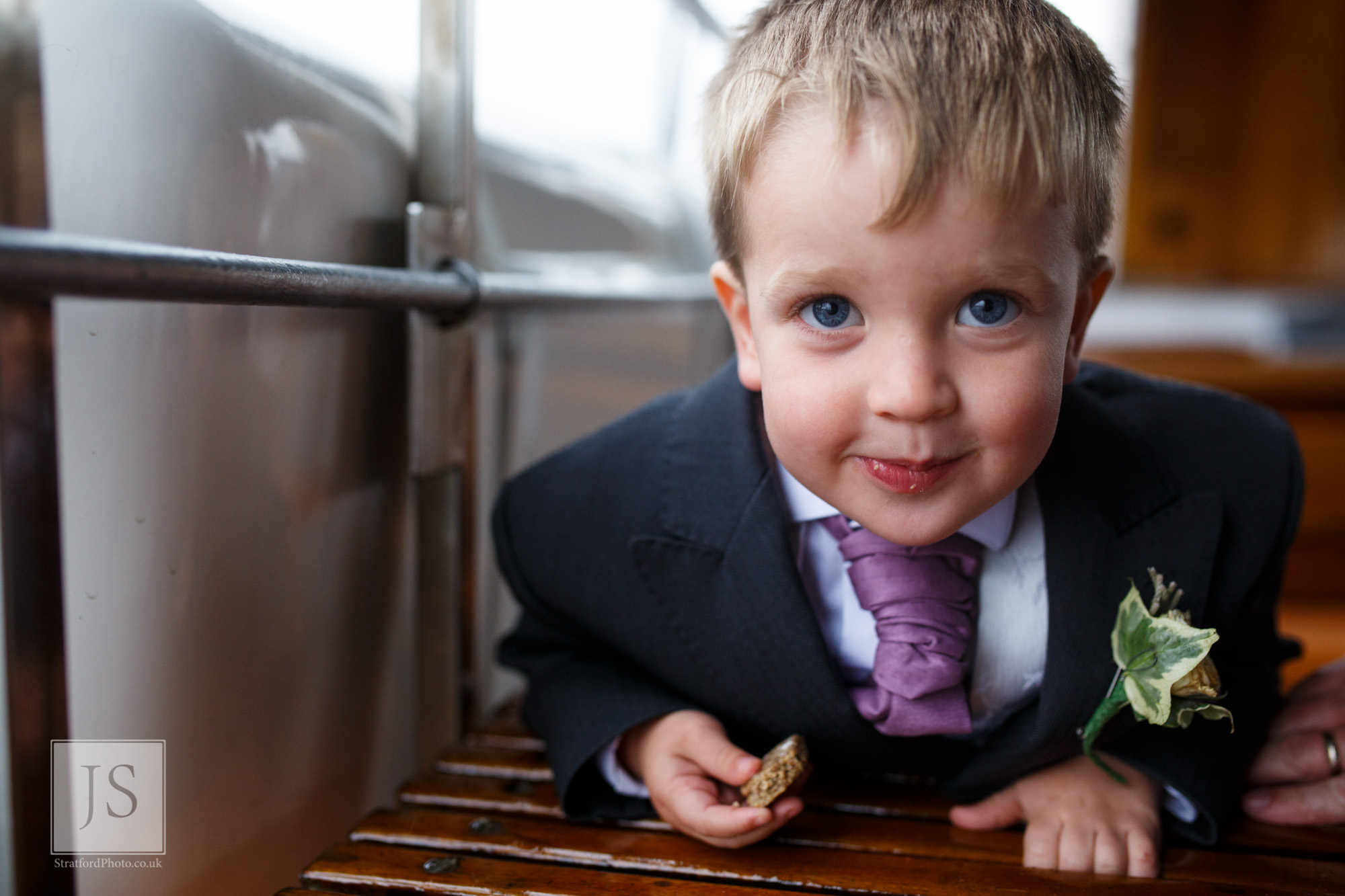 A young ring bearer smiles at the camera on a Lake Ullswater steamer boat.jpg