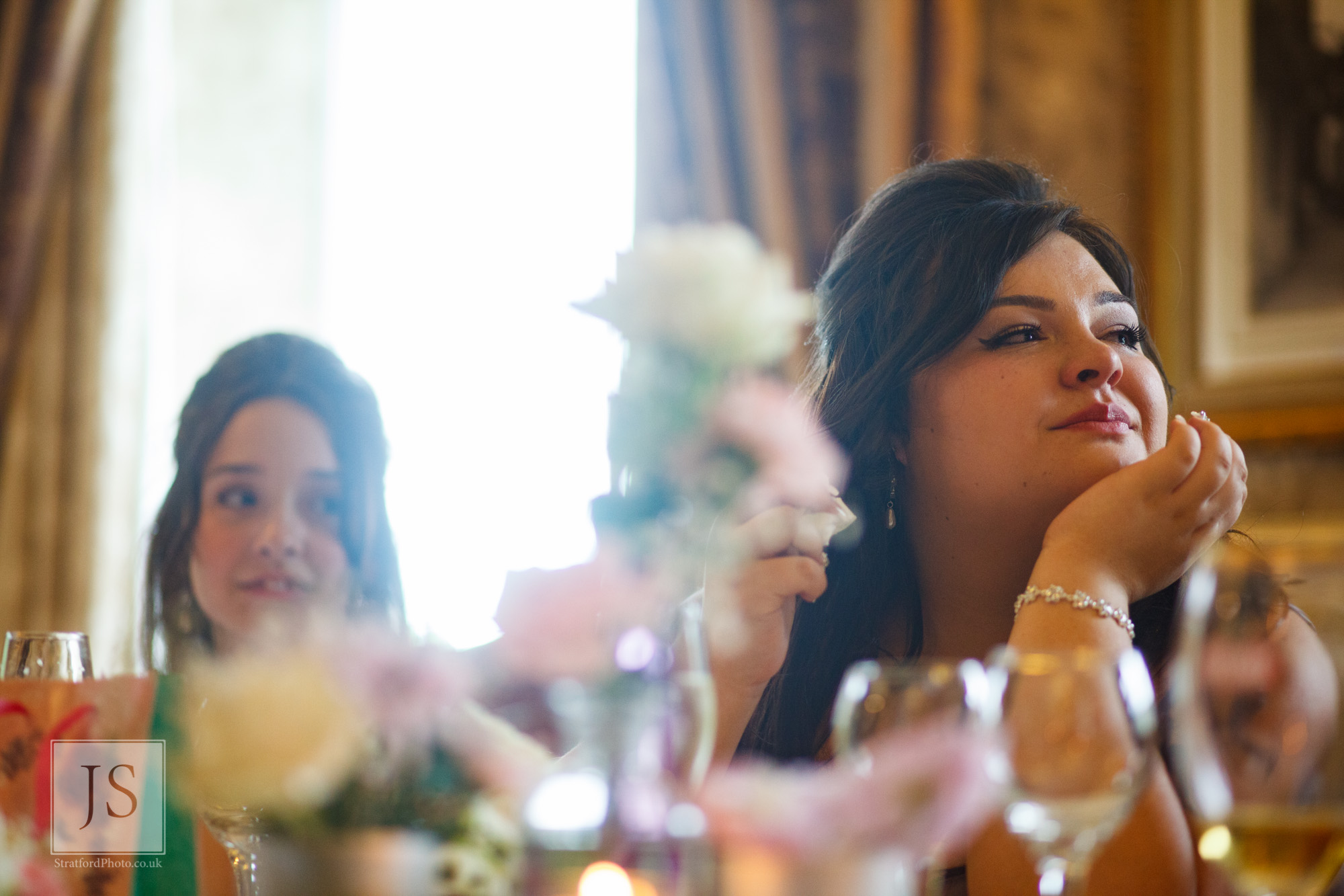 An emotional bridesmaid listens to a speech.jpg