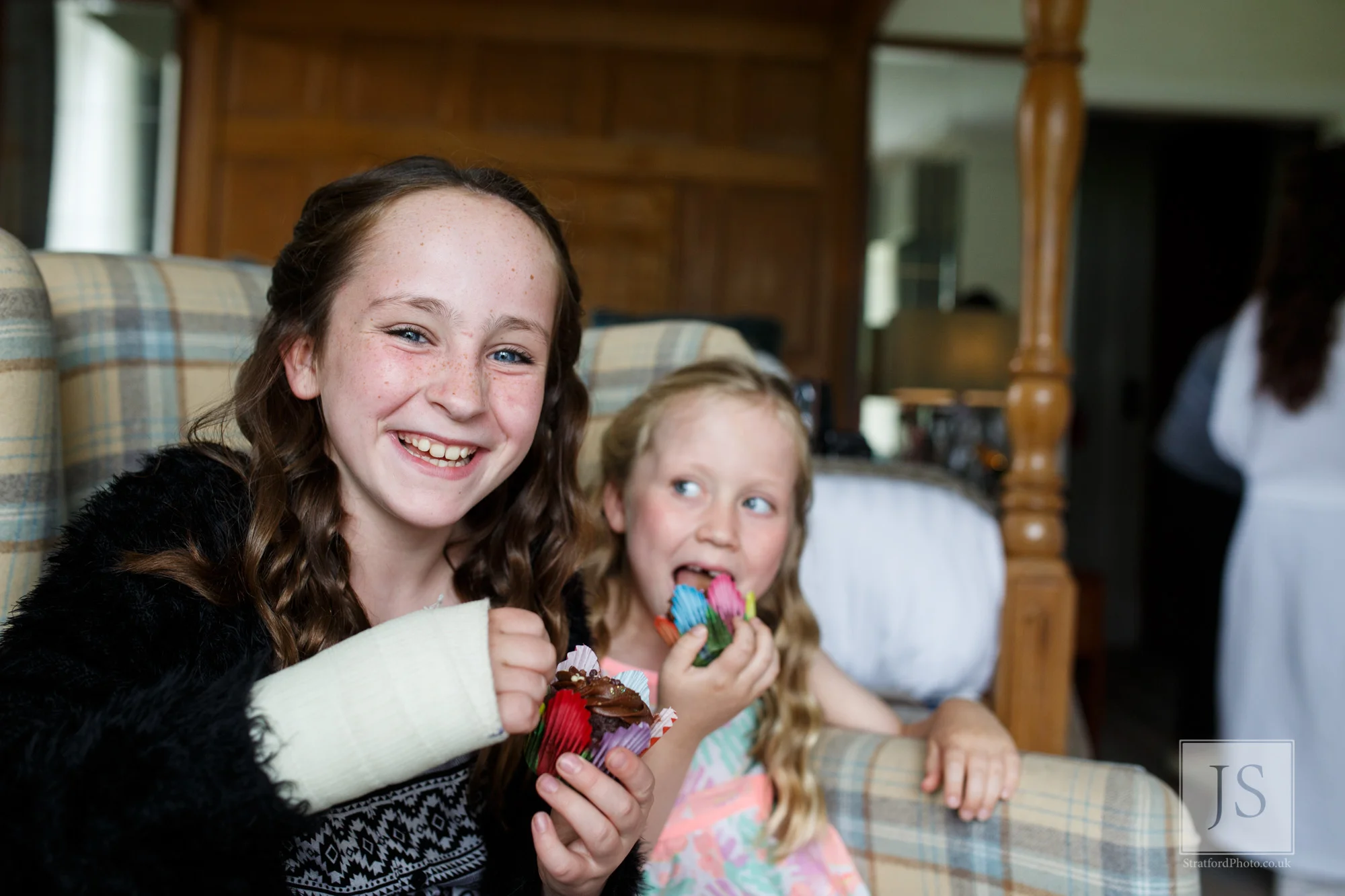 Two beautiful young girls enjoy a cupcake on the morning of a wedding.jpg