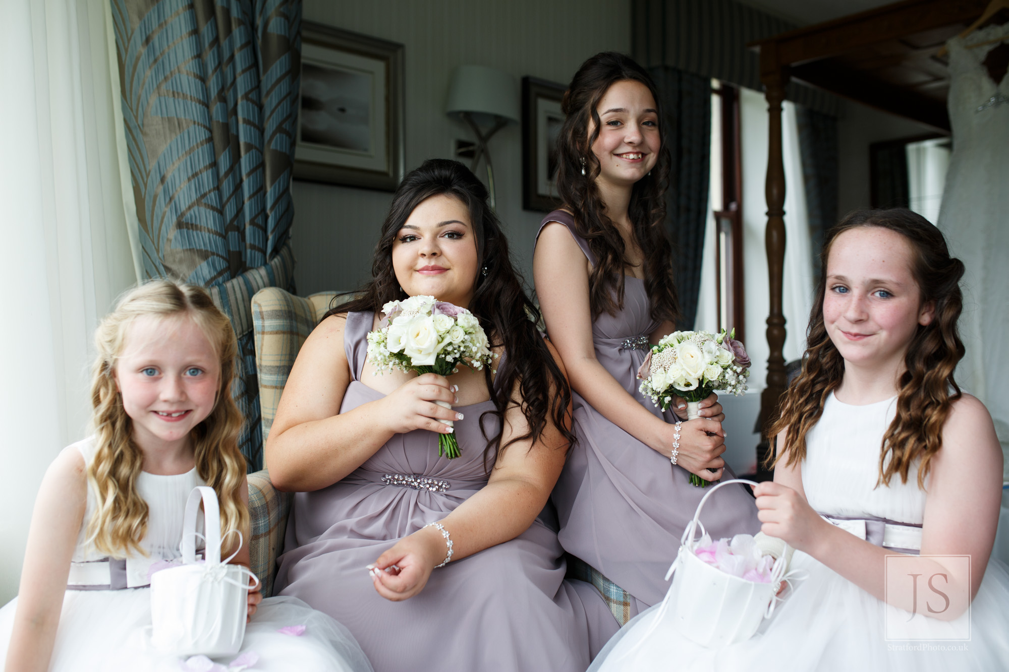 Two bridesmaids and flower girls pose for a photo.jpg