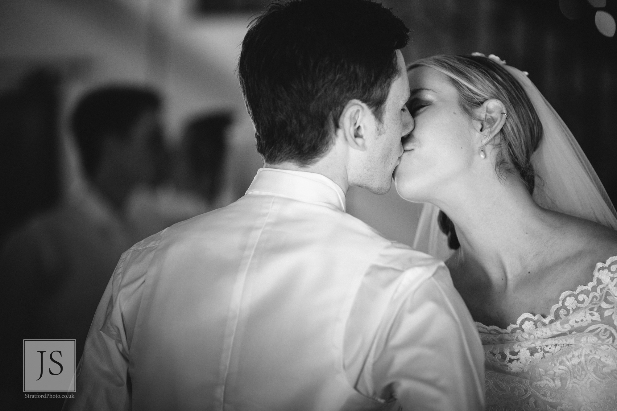 A bride and groom share a romantic kiss.jpg