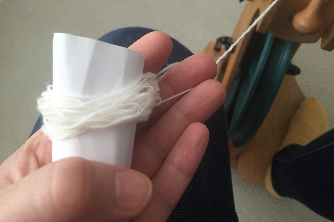 A rolled up piece of paper makes it so much easier to to ply yarn from a center pull ball. No tangles! 