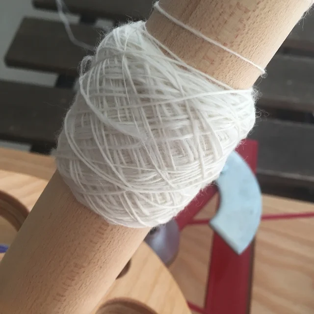 A rolled up piece of paper makes it so much easier to to ply yarn from a center pull ball. No tangles! 