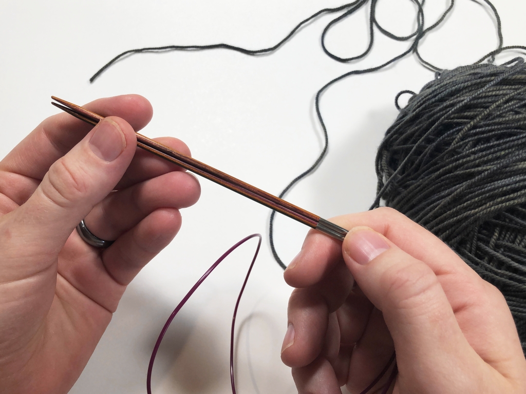 Learn how to work Judy’s Magic Cast-On to seamlessly start knitting in knit or purl. It’s a great cast-on to use for toe-up socks and other projects that start from the center out. #knitting #knittingcaston #knittingtutorials | withwool.com
