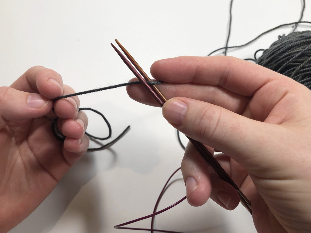 Learn how to work Judy’s Magic Cast-On to seamlessly start knitting in knit or purl. It’s a great cast-on to use for toe-up socks and other projects that start from the center out. #knitting #knittingcaston #knittingtutorials | withwool.com