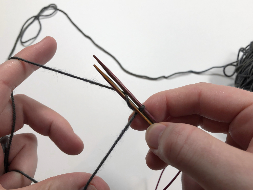 Learn how to work Judy’s Magic Cast-On to seamlessly start knitting in knit or purl. It’s a great cast-on to use for toe-up socks and other projects that start from the center out. #knitting #knittingcaston #knittingtutorials | withwool.com