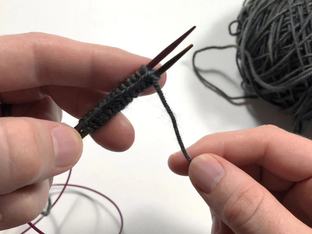 Learn how to work Judy’s Magic Cast-On to seamlessly start knitting in knit or purl. It’s a great cast-on to use for toe-up socks and other projects that start from the center out. #knitting #knittingcaston #knittingtutorials | withwool.com
