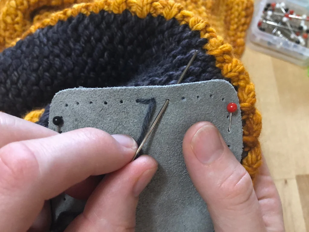 Learn how to sew soles onto your slippers for extra grip and added durability. #knitting | withwool.com