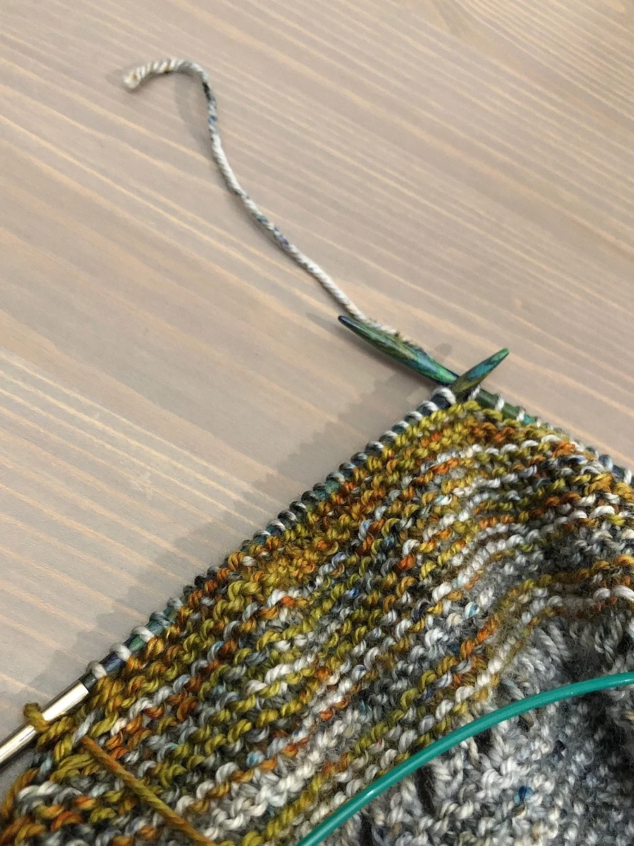 Ran out of yarn with just a few stitches left in the row. Sock yarn leftovers to the rescue! Yarn Chicken Shawl || withwool.com