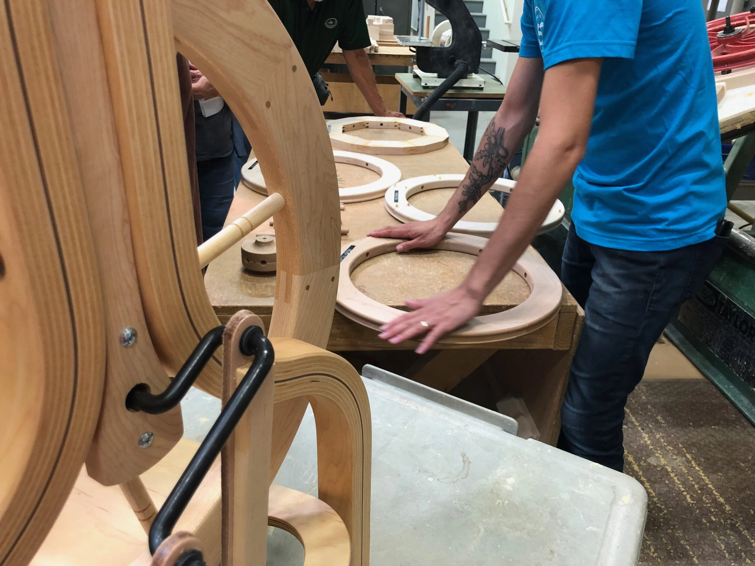 Tour guide explaining the process of making the wooden wheel for a spinning wheel. Celebrating Schacht’s 50th Anniversary || withwool.com #schacht50years