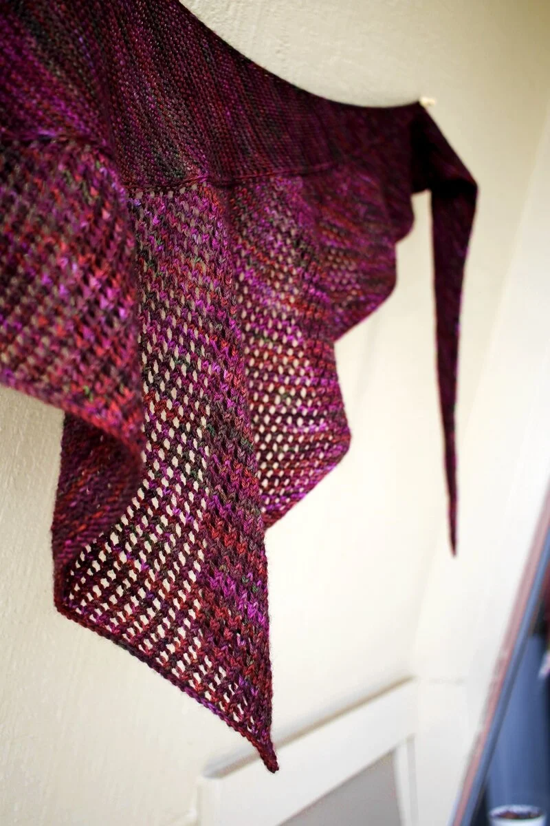A close up of the mesh section of a Curve of a Boat shawl knit with a variegated magenta yarn. #knitting #finished shawl Shawl Parade | withwool.com