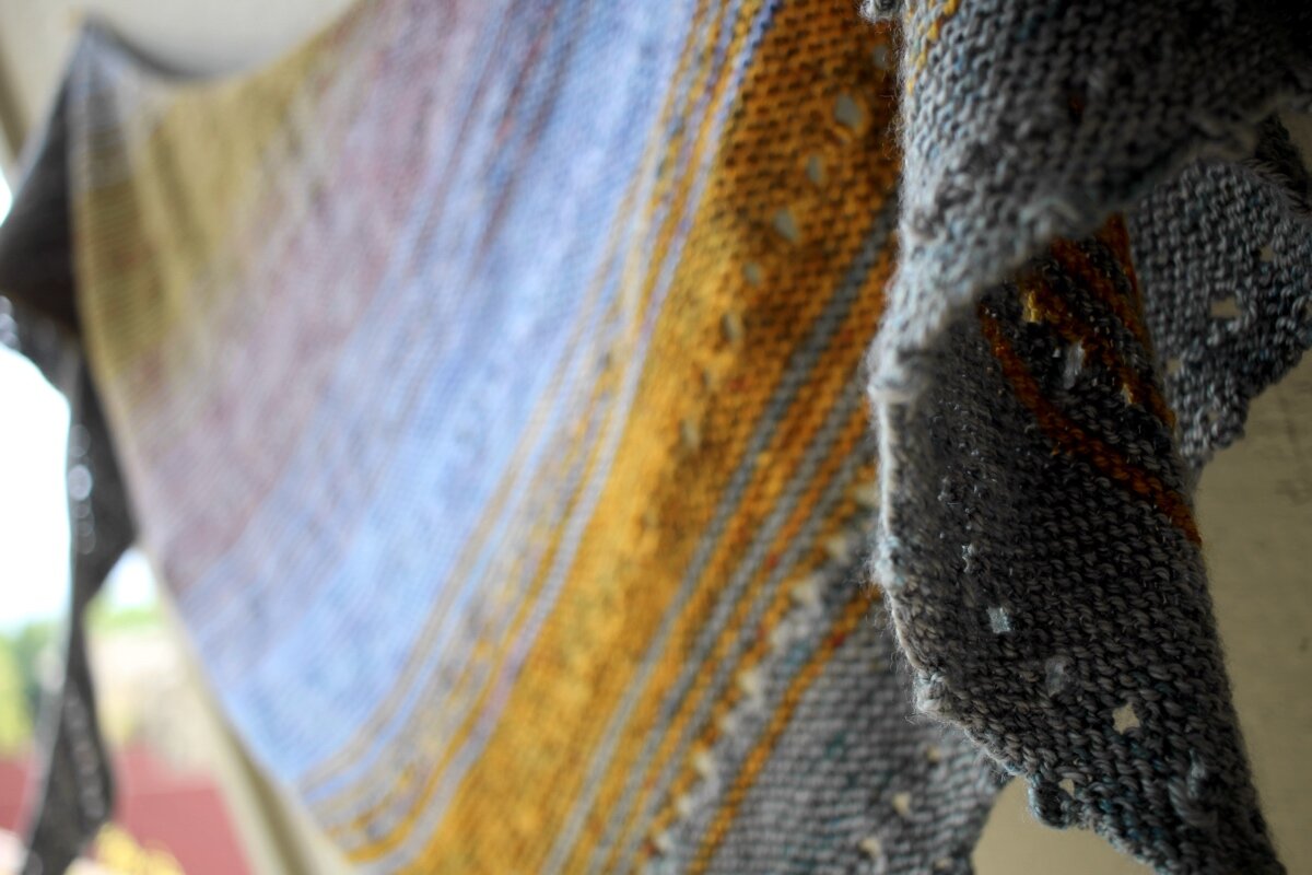 A slightly out of focus look at the color progression of the Free Your Fade shawl. #knitting #FreeYourFade #AndreaMowry Shawl Parade | withwool.com