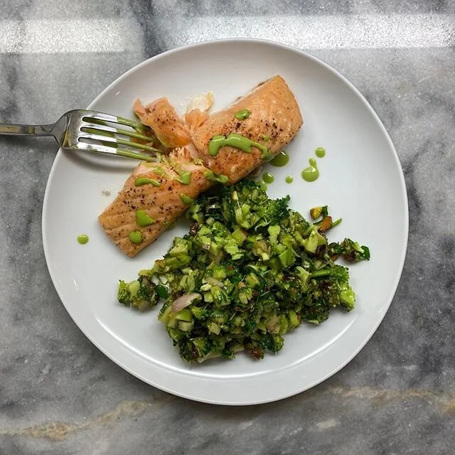 Simple wins in complicated times. Roasted salt-and-pepper salmon with a drizzle of aji verde, served alongside the @healthy_ish / @parachutechicago tangy-sweet broccoli spoon salad made with dates, shallots, plenty of fresh cilantro, and roasted pist