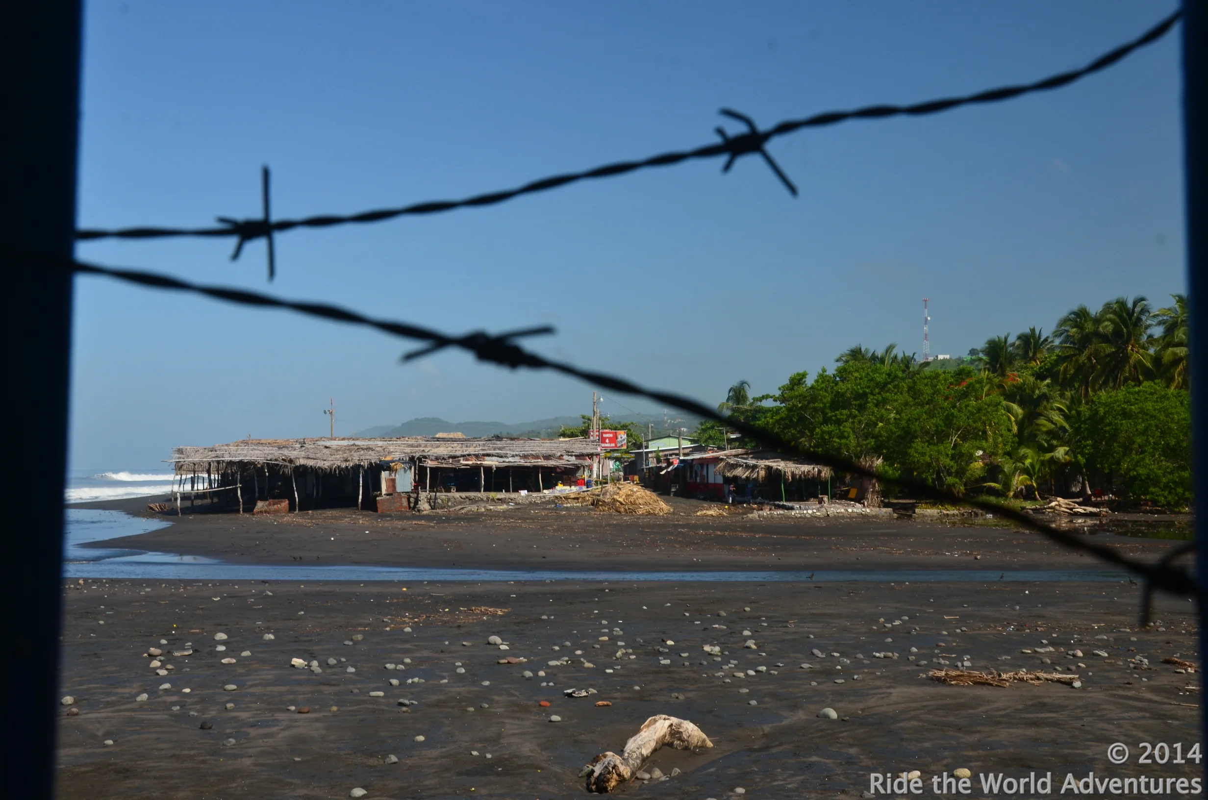 Peering through the barbed wire that surrounded the beach front hotel.