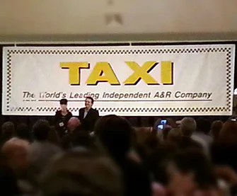 Diane Warren accepting a lifetime achievement award from Michael Laskow