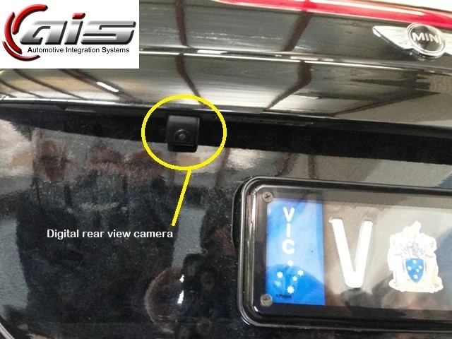 The rear view camera is mounted under the rear ledge.