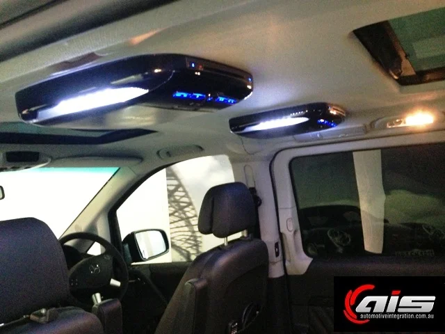 The dual screen system is placed not to block rear view mirror visibility.