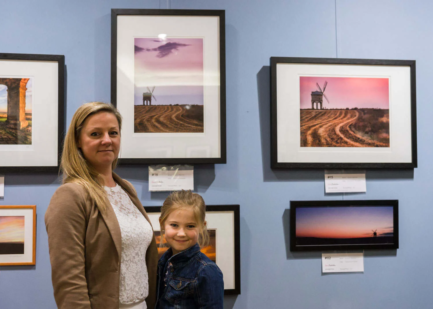 Lynsey Melville proudly standing with her daughter next to her two Chesterton images