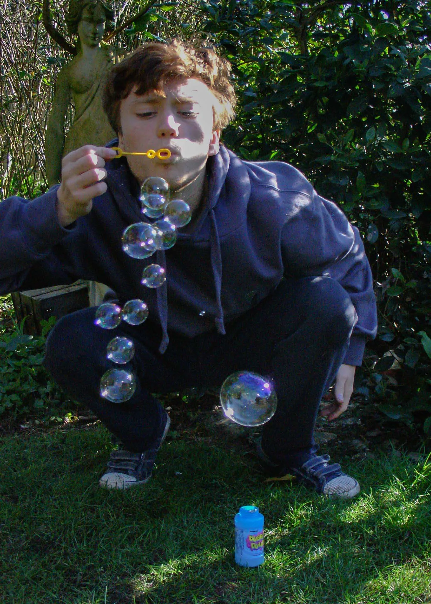 Title of Image:  Bubble dayDescription: A live photo and a movement + action shotHow did you take the shot? We had to make sure it shot fast we pressed the button half way to focus then we held the button all the way down once he started blowing bub…