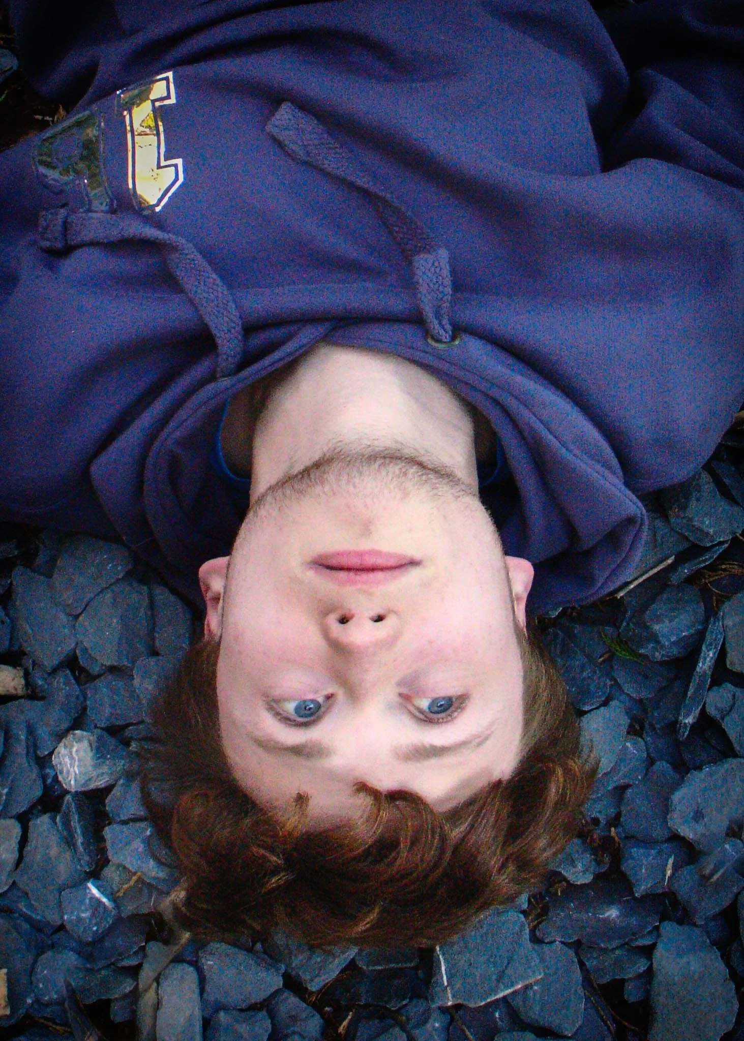 Title of Image:  Gulliver’s Grave My Brother is upside down and looks like his has a face upside down.How did you take the shot? My brother sat on the swing and then leant backwards until he was upside down. Then I took the photo with h…