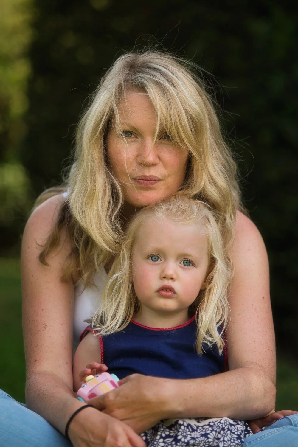 Mother and young daughter relaxed family portrait photographed outdoors