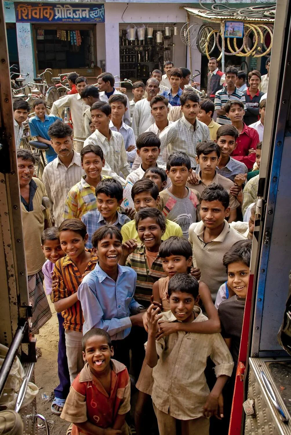 Group of children crowding together to greet the photographer