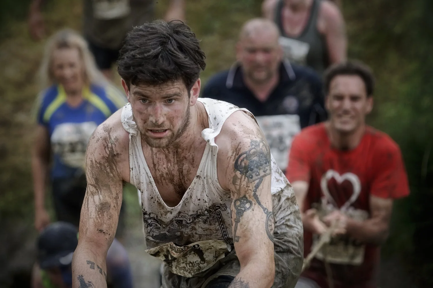 Mud runner showing effort and emotion during an obstacle event