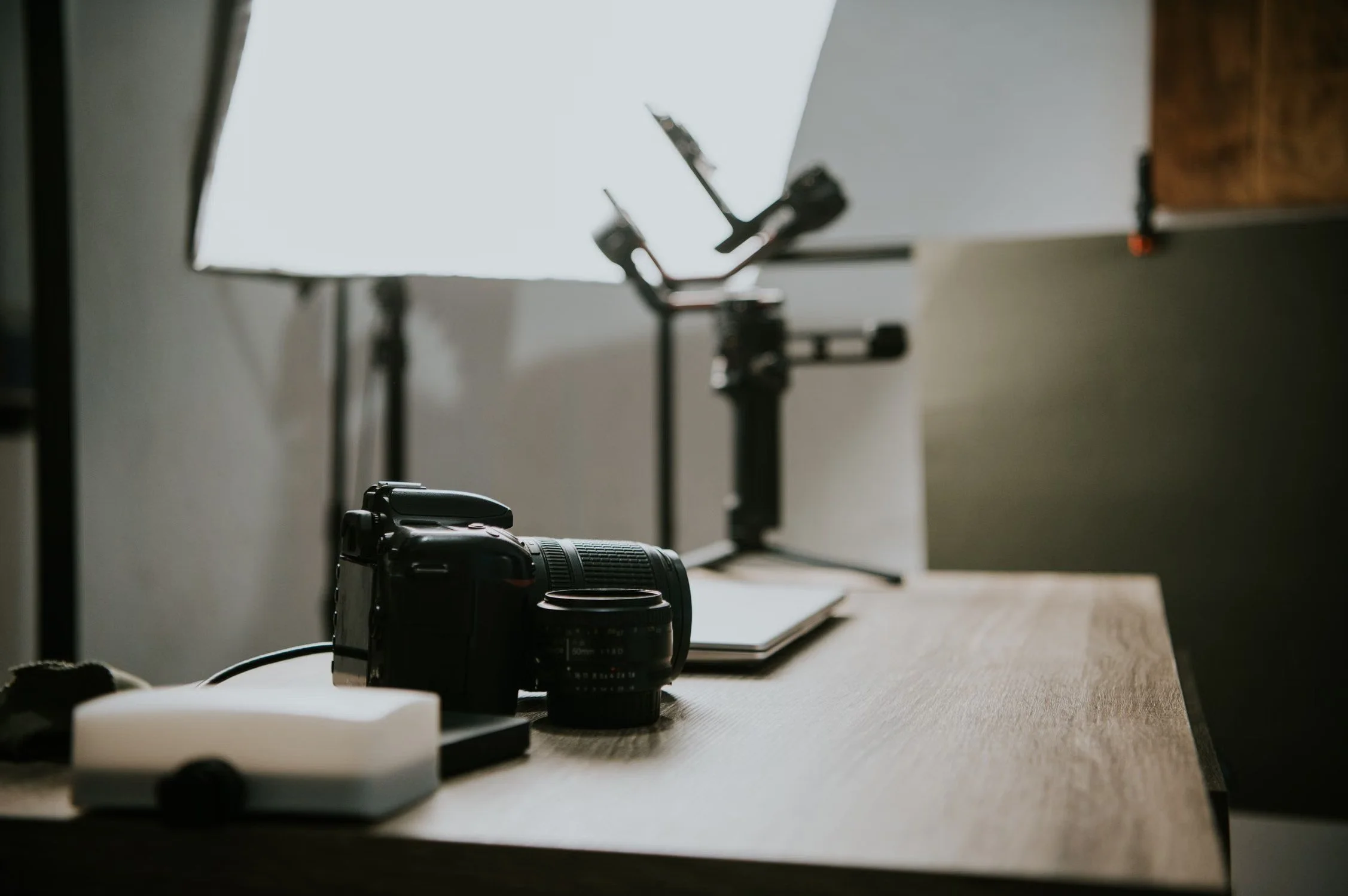 Camera and lens on a wooden desk for a student photo essay project