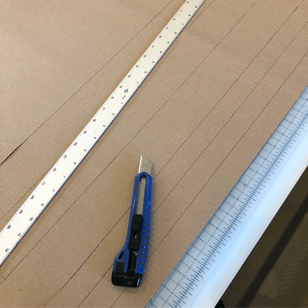 Cut Cardboard strips for the scratcher bed.