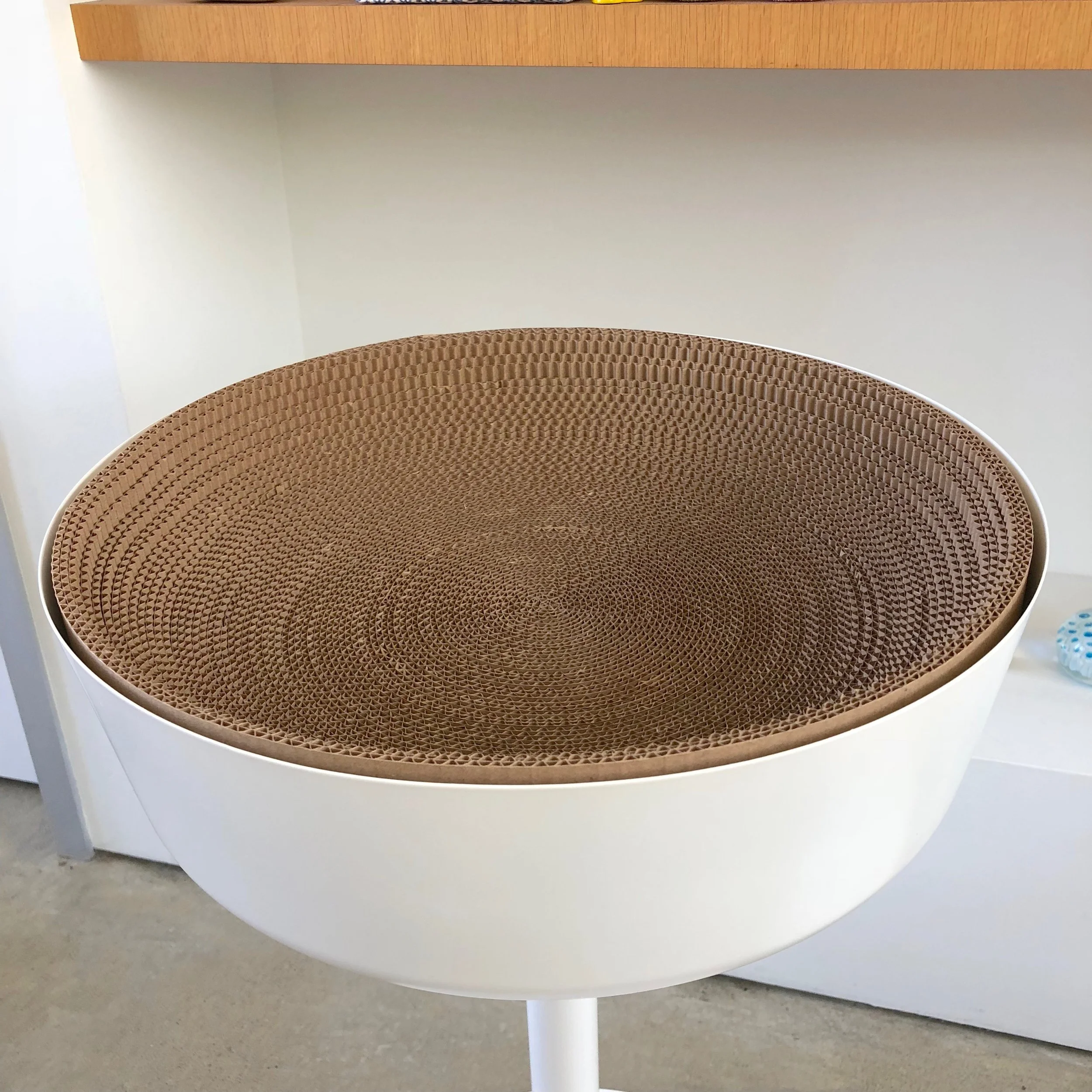 Cardboard pushed down to form the bowl shape.