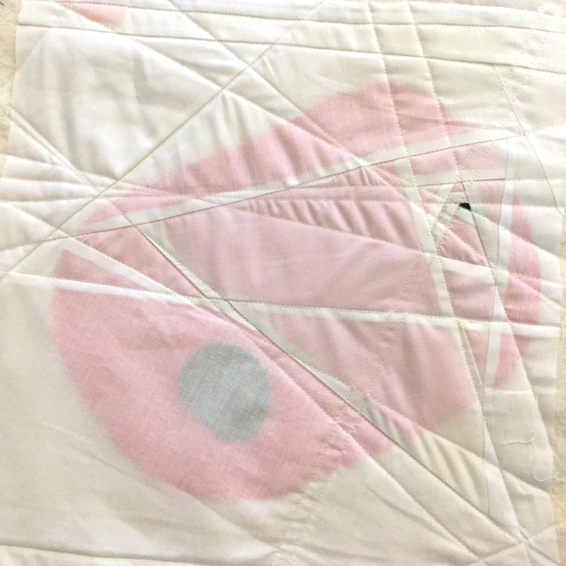 I added focus points to the scroll by sandwiching colored scraps between the outer layer and the cotton batting. I admit that it was quite random at this stage. I really didn’t know what my story was going to be.