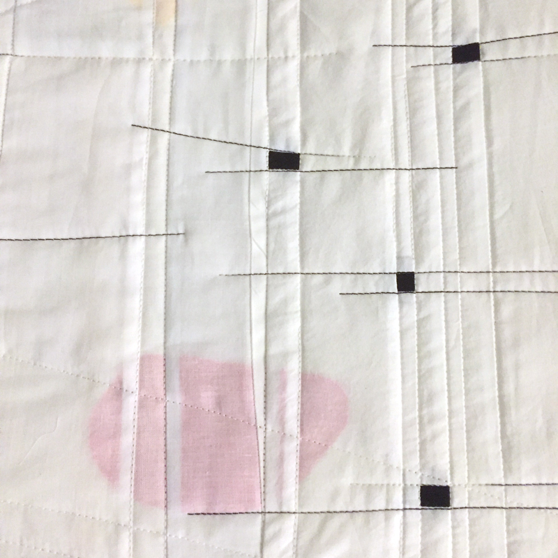  Next step was to stabilize the layers. I stitched along each seam in white or black thread. If the seam was horizontal I added a black thread line that highlighted it to add a sense of action to the piece. There were a lot of seams.  