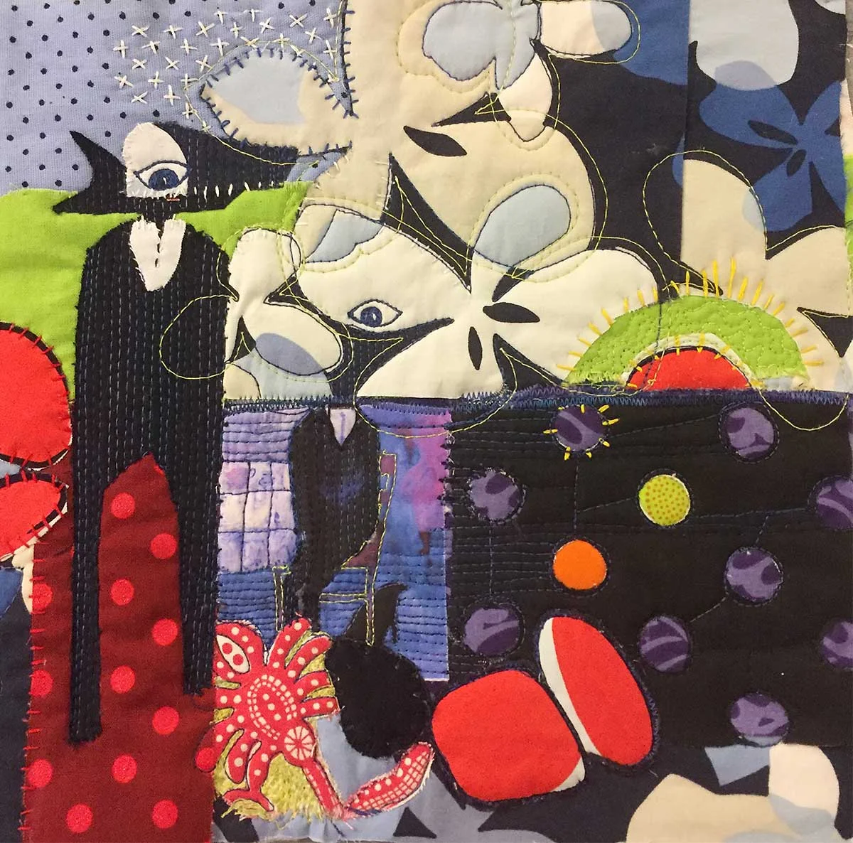 Patterned fabrics add a sense of mystery to this composition. Stitching adds texture.