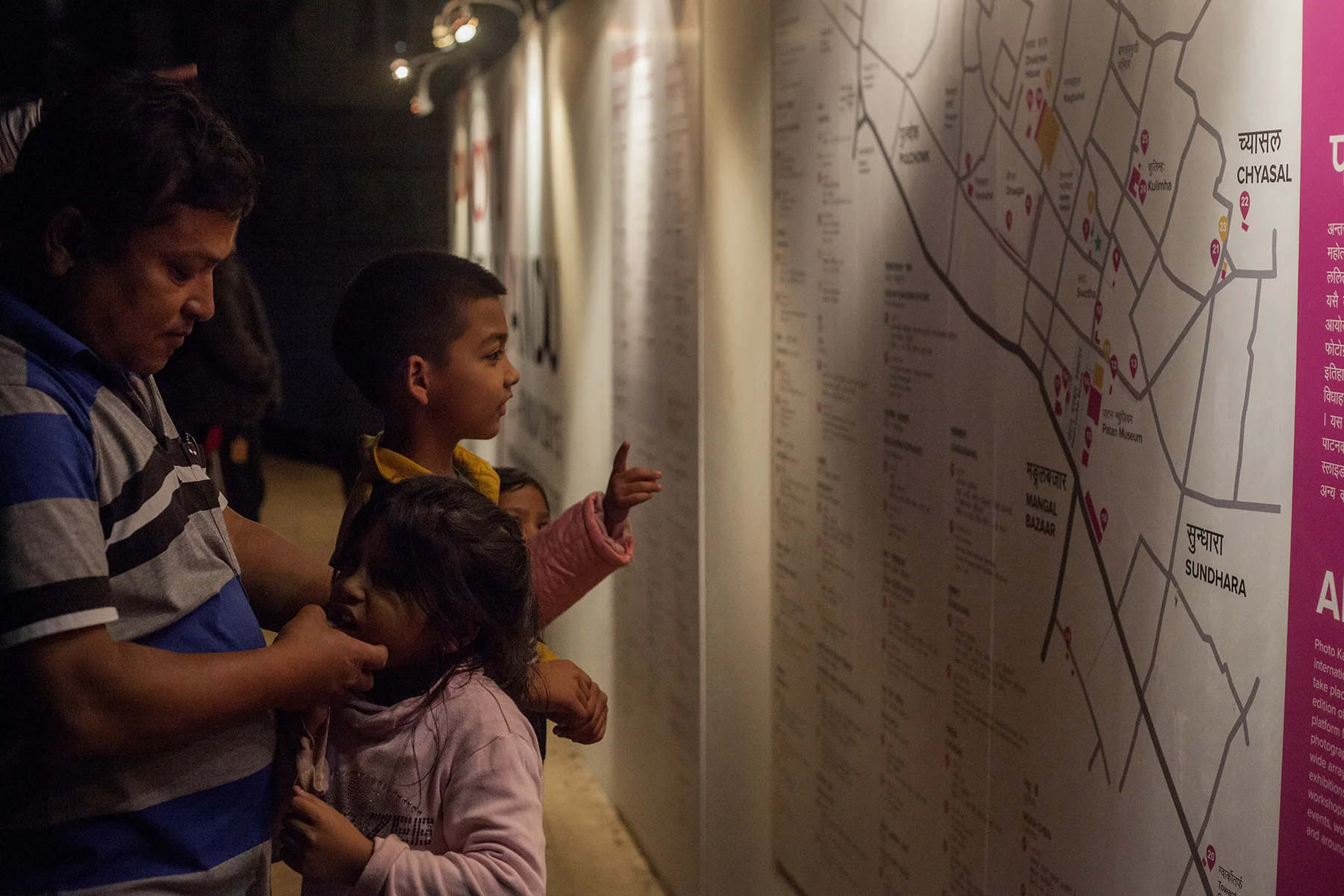 kids_family_interacting_with_big_map.jpeg