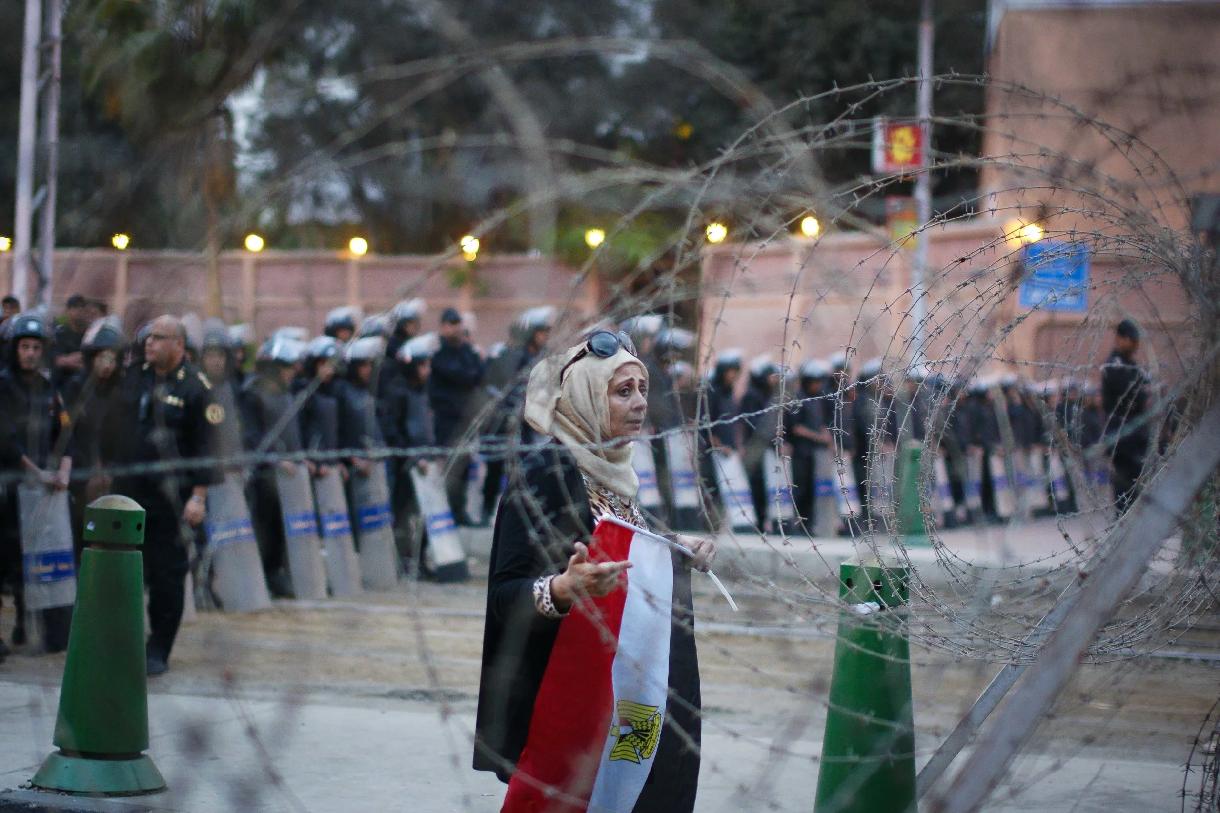 A woman (somehow) got through to the other side, and tried to calm the protestors. She told them not to be violent and to protest peacefully Unfortunately, people started throwing balls of paper at her.