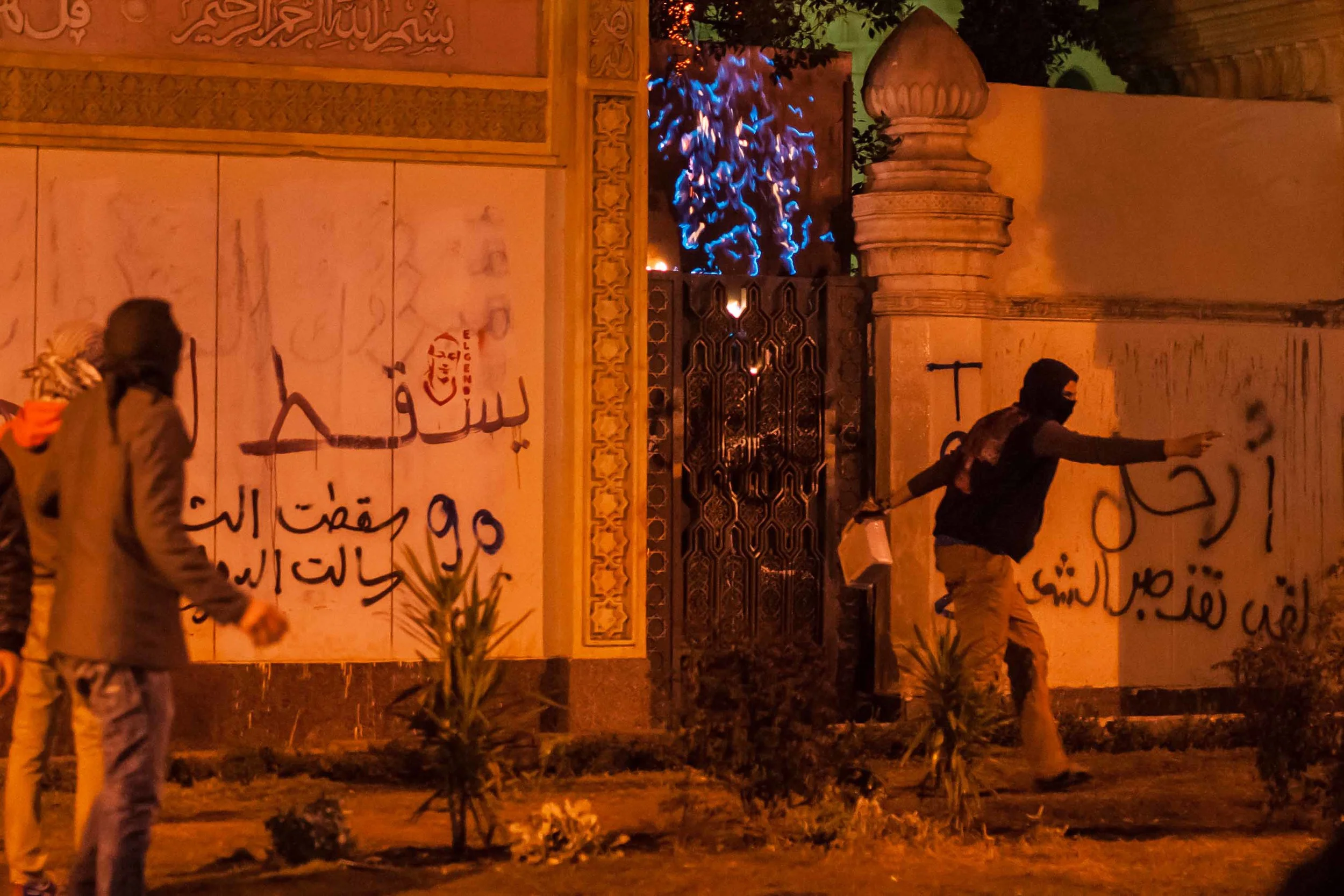 Members of the Black Bloc set fire to another gate at the palace. Moments later, the police moved in.