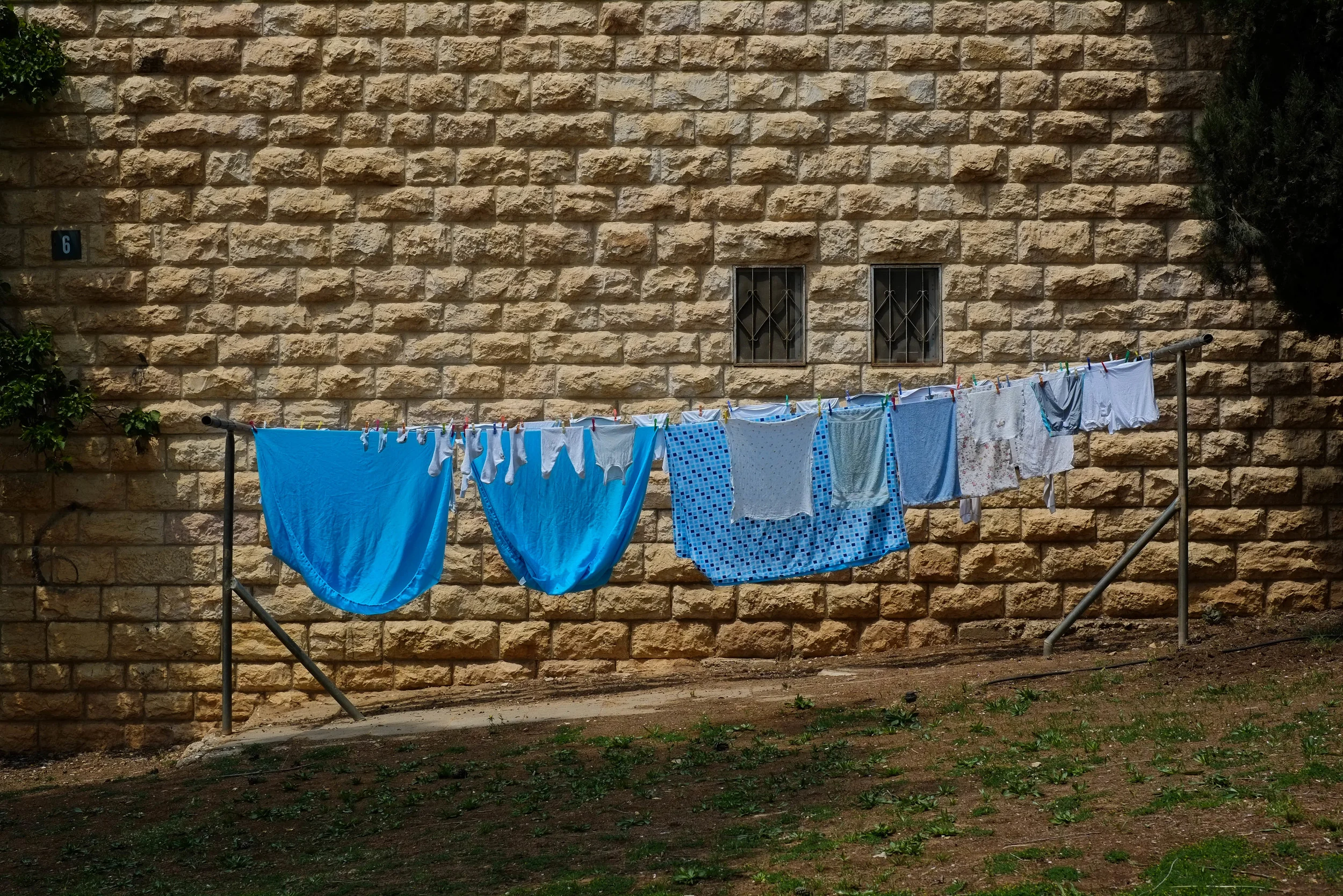 The West Bank city of Hebron is divided. Economic strangulation by the israeli government has closed more than 1,800 shops, and the 500 israeli settlers in the area have made this area a focal point for clashes. Daily life belies the dark reality faced by the 250,000 Palestinian residents, 77% of which live below the poverty line.