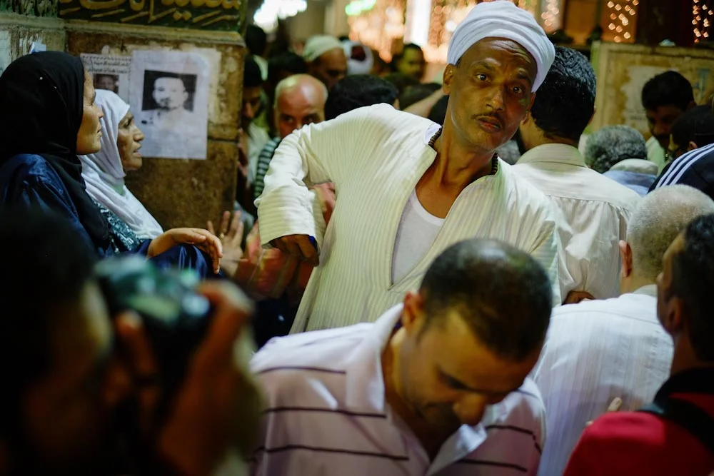 Thousands try to file through the overwhelmed entrances of the Sayeda Zeinab mosque.