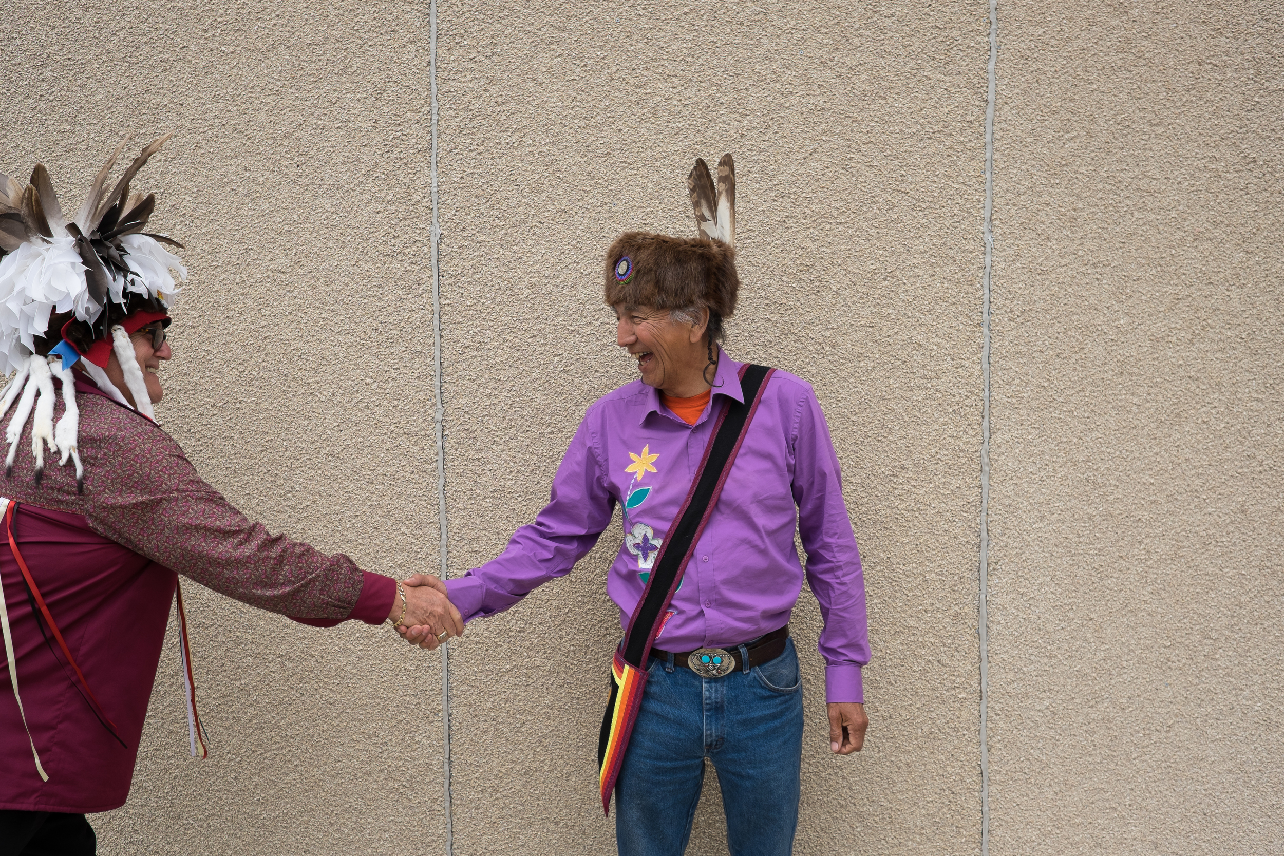 Runner Charlie Nelson (right) is greeted by New Credit Chief Brian LaForm during a celebratory event hosted by the community to welcome the torch. 