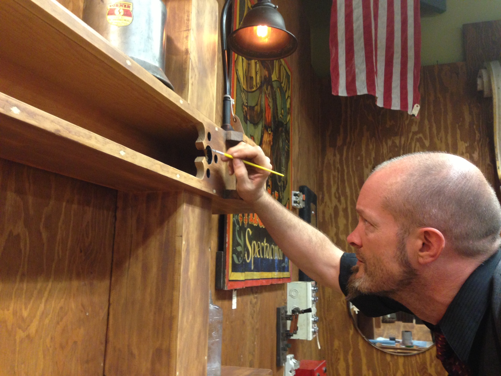 The finishing touches ~ Dark paint brings out the detail in the shelving.