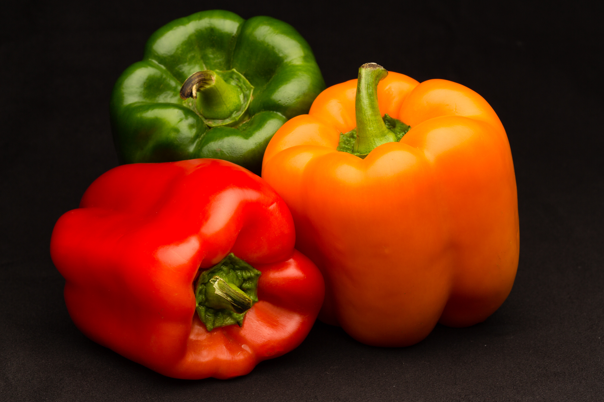 Professional food photo of red, green and orange bell peppers. Commercial photography