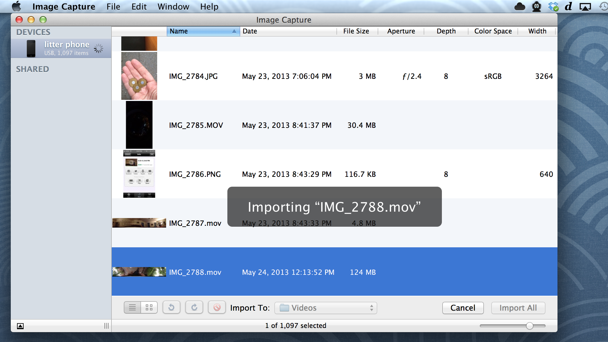 Use the free Image Capture utility or iPhoto to retrieve movies from your phone.