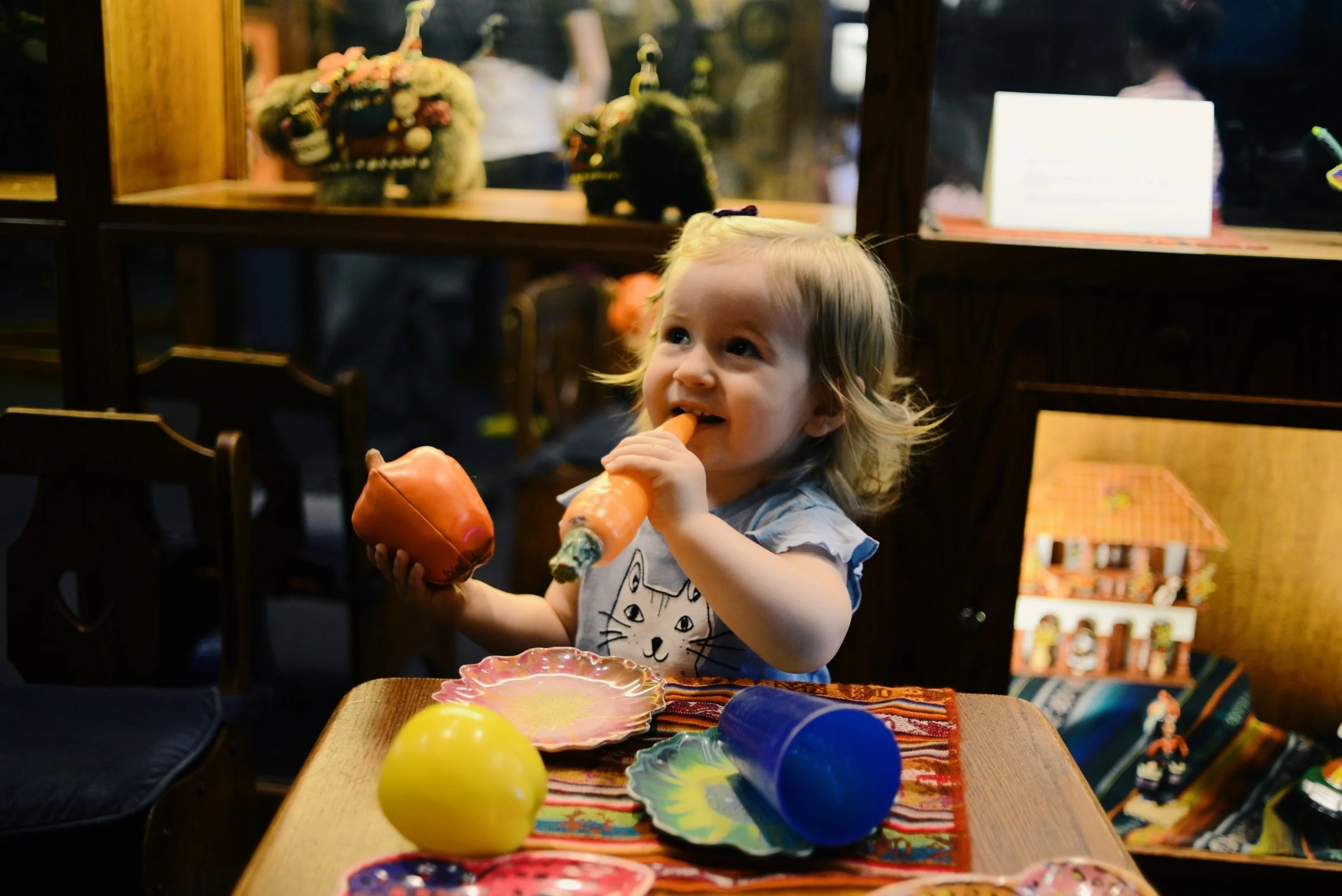 Lila playing with fake food.