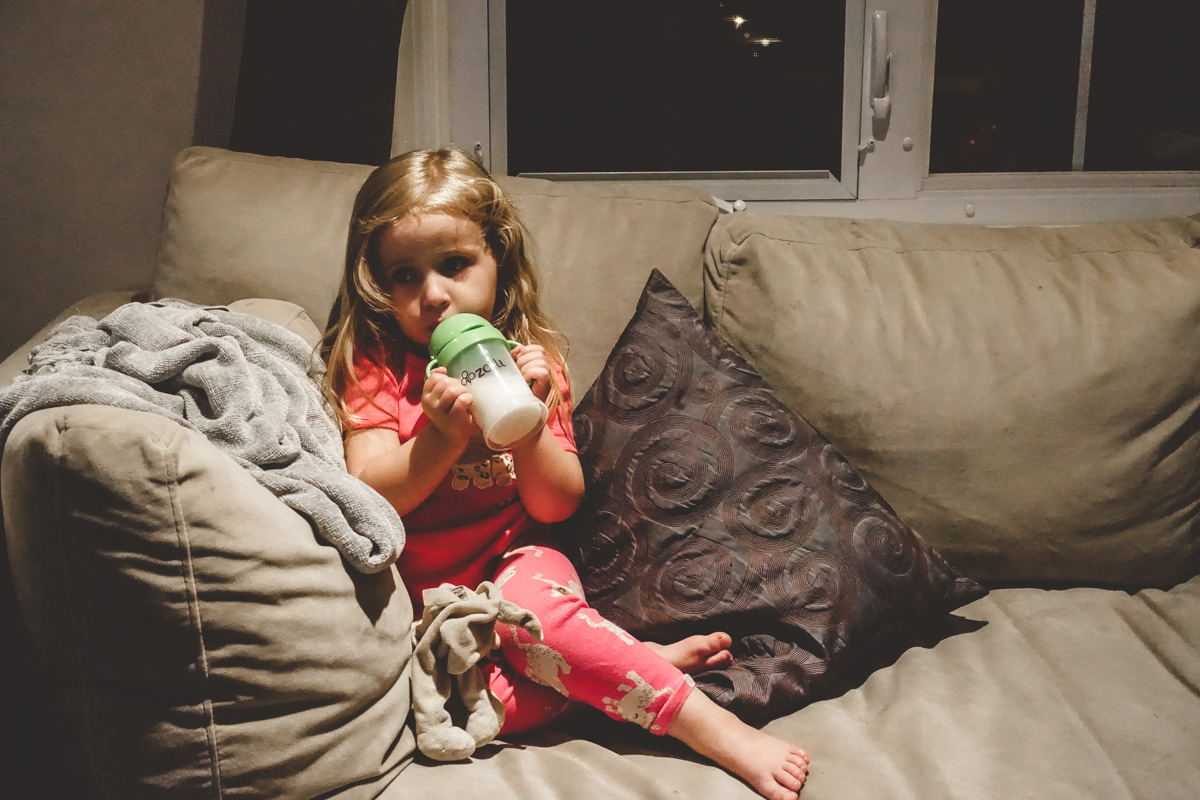 8:40pm: One kid in bed, the other having her milk.