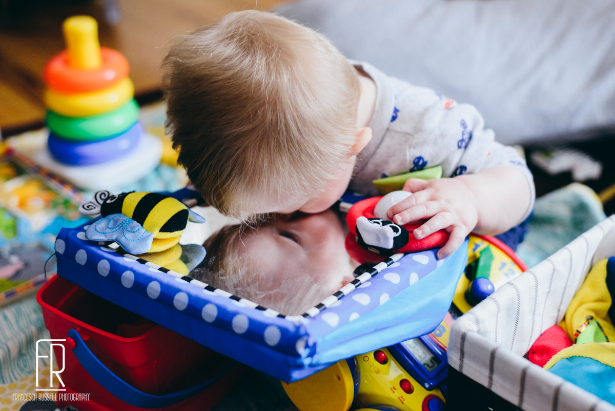 Kissing his reflection.