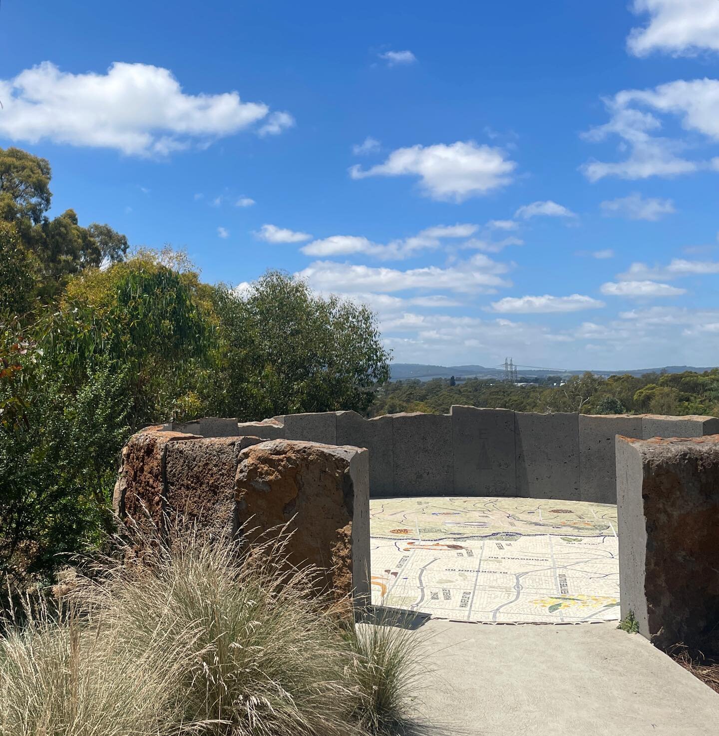 The hill top at Jells Park play space - a lookout point constructed from sawn basalt slabs featuring a mosaic map #landscapearchitecture