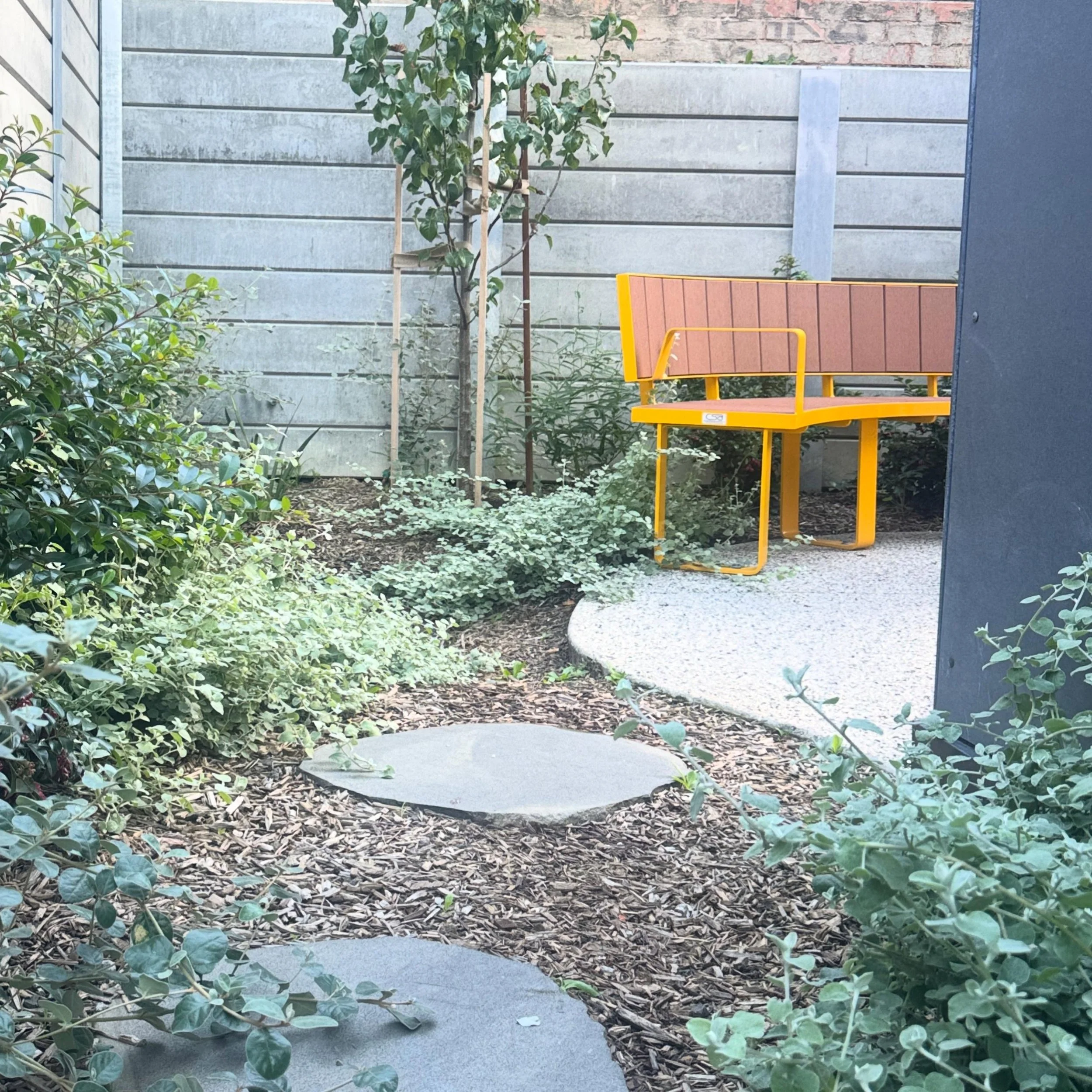 Making space for some outdoor seating and greenery on a tight social housing site in St Kilda.